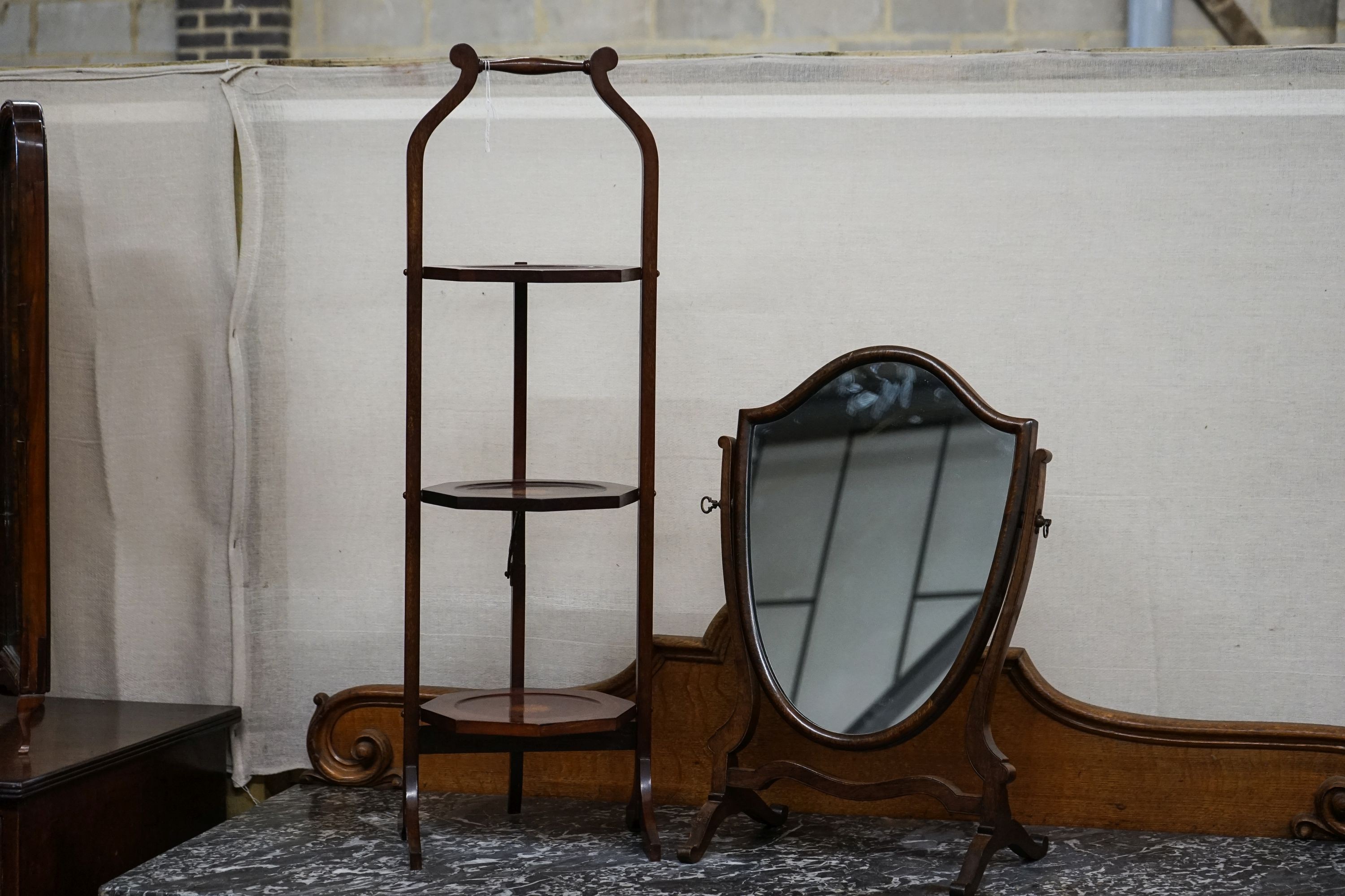 An Edwardian cake stand together with a skeleton framed toilet mirror